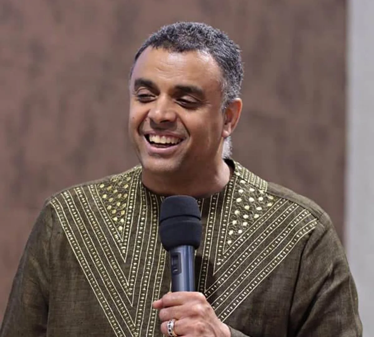 Bishop Dag Heward-Mills smiling, holding a microphone