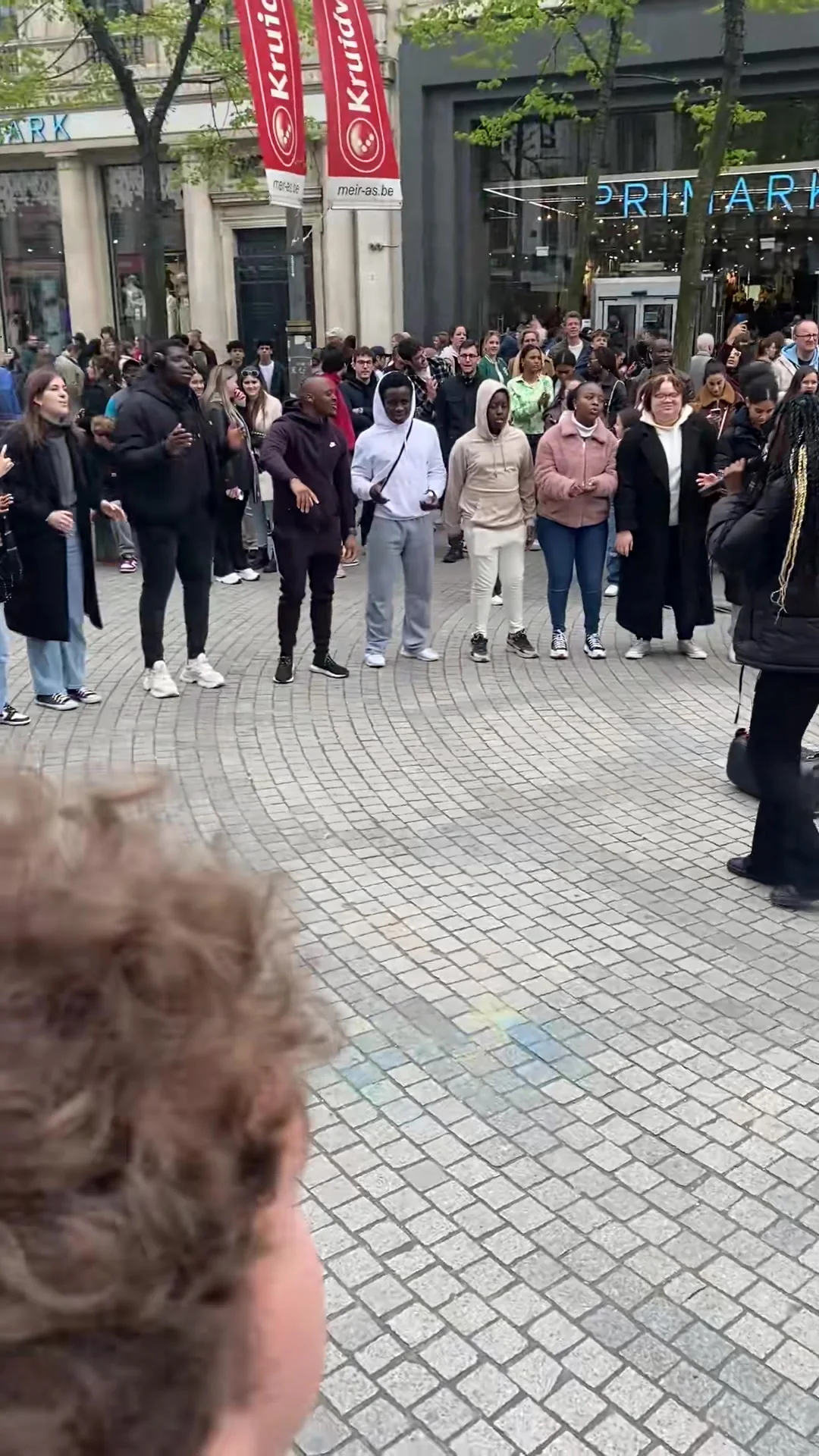 A crowd gathered on the Meir around a street preacher