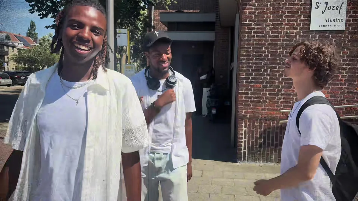 A smiling young man outside the St Jozef church in Merksem